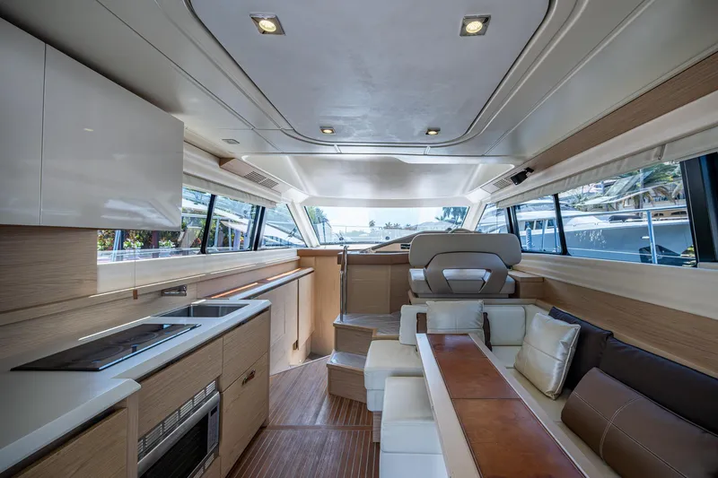 Slide: The Image of Luxurious interior of 2015 Beneteau Monte Carlo yacht with modern kitchen and seating area. - 46