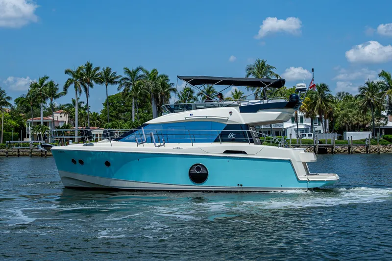 Slide: The Image of 2015 Beneteau Monte Carlo yacht cruising on a sunny day with palm trees in the background. - 8