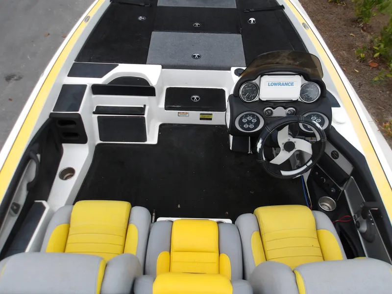 Slide: The Image of 2006 Triton 20X2 boat interior with yellow seats and modern dashboard. - 6