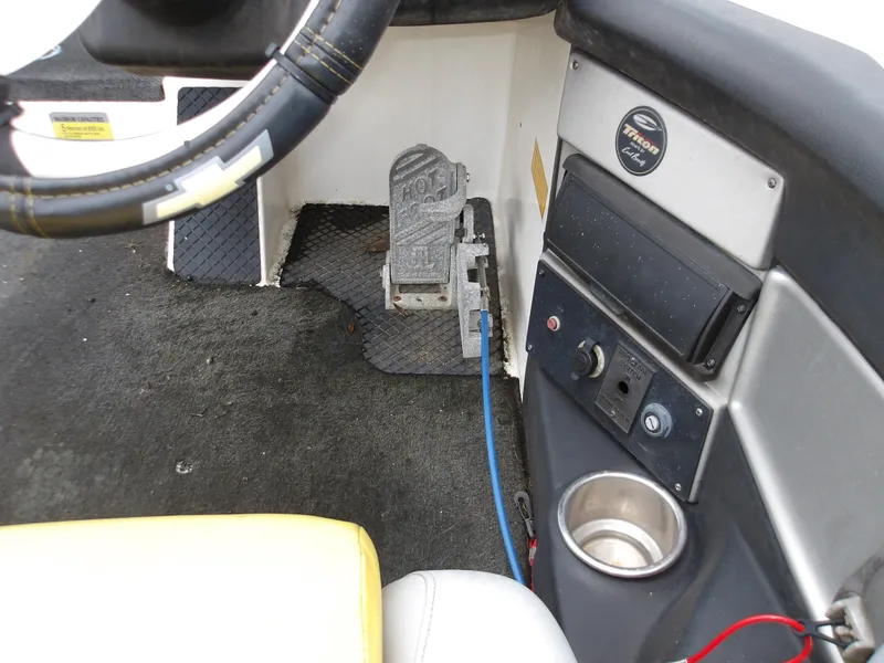 Slide: The Image of 2006 Triton 20X2 boat interior with steering wheel, foot pedal, and control panel. - 8