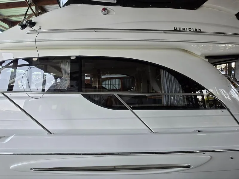 Slide: The Image of 2004 Meridian 381 Sedan yacht side view with sleek design and large windows. - 11