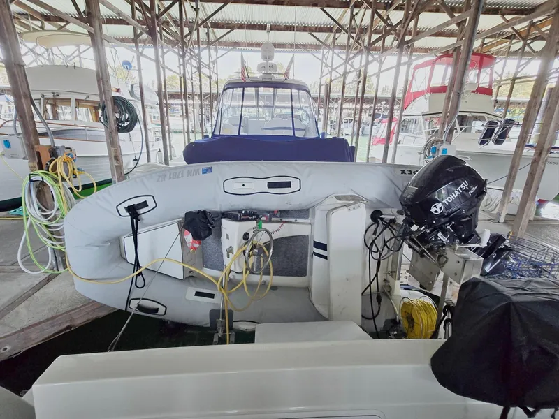 Slide: The Image of 2004 Meridian 381 Sedan docked with inflatable boat and outboard motor in marina. - 13