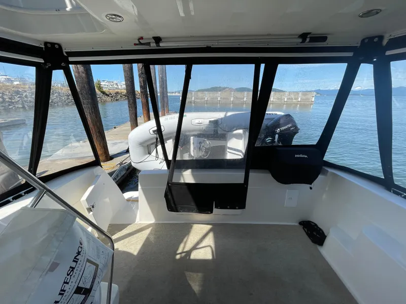 Slide: The Image of Interior view of a 2004 Meridian 381 Sedan boat with clear windows overlooking the water. - 16