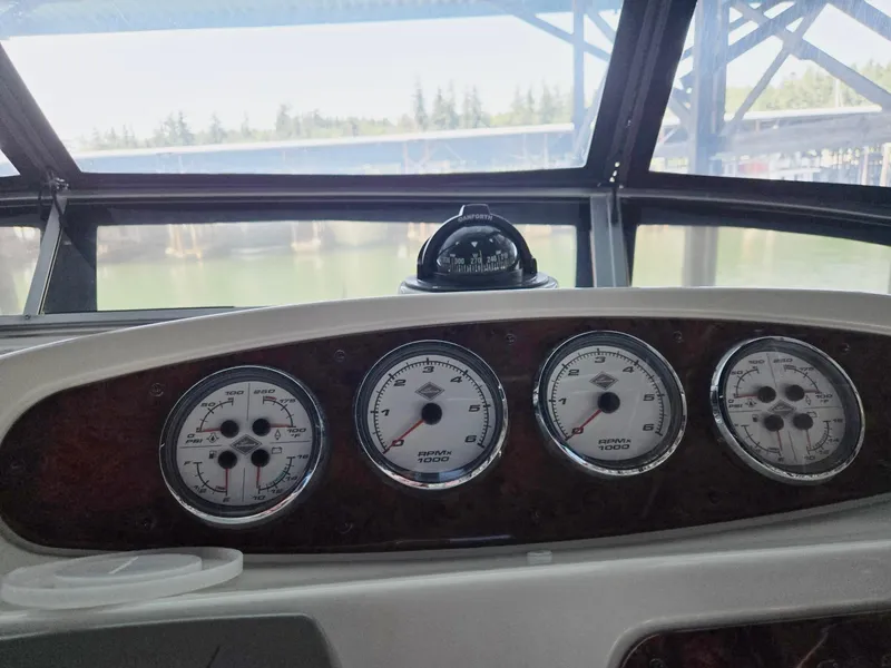 Slide: The Image of Dashboard of a 2004 Meridian 381 Sedan boat with gauges and compass. - 24