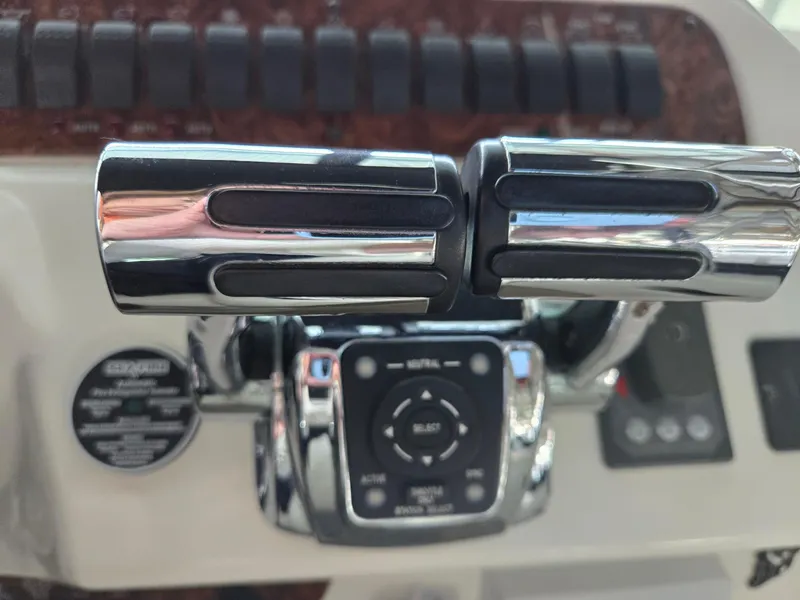 Slide: The Image of Control panel of a 2004 Meridian 381 Sedan boat with chrome throttle levers. - 25