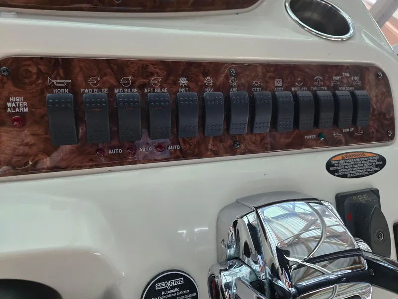 Slide: The Image of Control panel of a 2004 Meridian 381 Sedan boat with various switches and labels. - 26