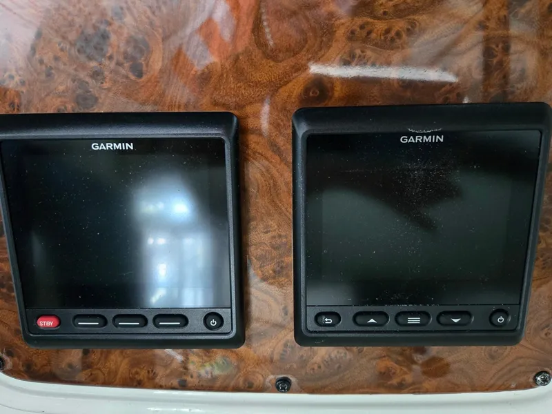 Slide: The Image of Garmin navigation screens on a 2004 Meridian 381 Sedan dashboard. - 28