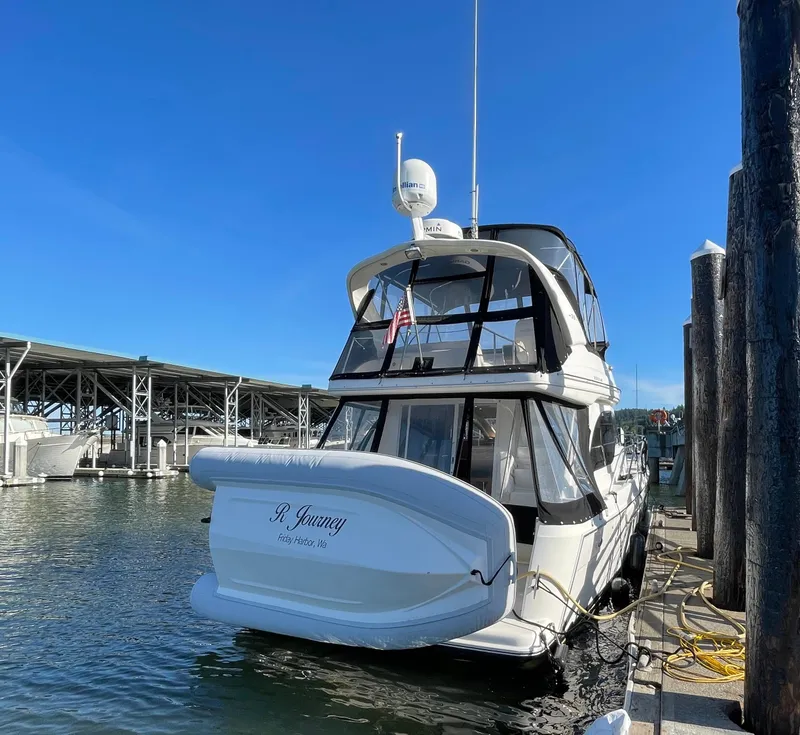 Slide: The Image of 2004 Meridian 381 Sedan yacht docked at marina under clear blue sky. - 3