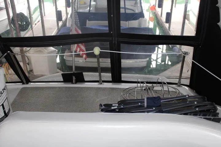 Slide: The Image of 2004 Meridian 381 Sedan interior with docked boats and American flag in background. - 31