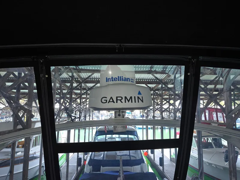 Slide: The Image of 2004 Meridian 381 Sedan with Garmin and Intellian equipment in a marina setting. - 32