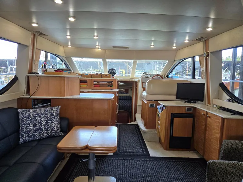 Slide: The Image of Interior of a 2004 Meridian 381 Sedan yacht, featuring a spacious, well-lit cabin. - 34