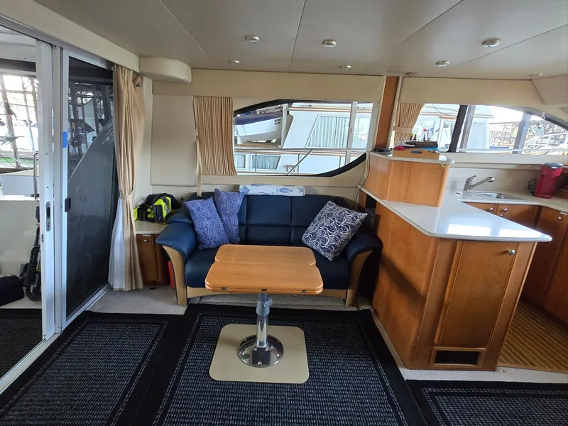 Slide: The Image of Interior of 2004 Meridian 381 Sedan yacht with sofa, table, and kitchenette. - 36