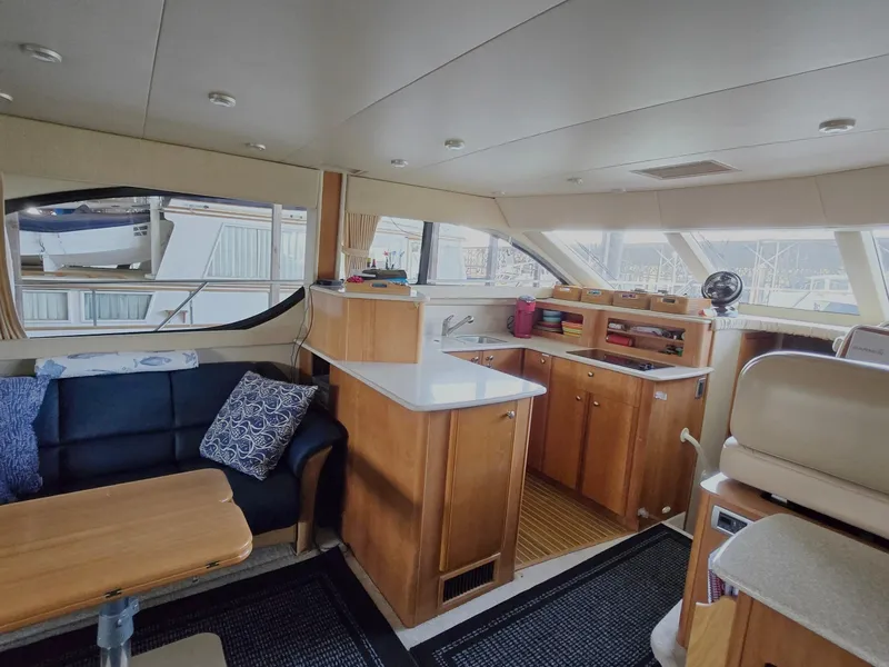 Slide: The Image of Interior of 2004 Meridian 381 Sedan yacht with modern kitchen and seating area. - 38