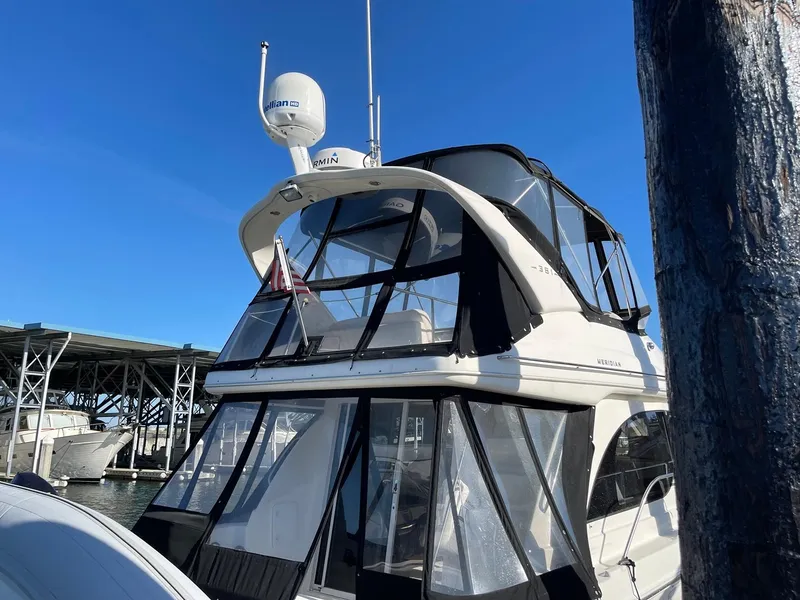 Slide: The Image of 2004 Meridian 381 Sedan yacht docked under clear blue sky. - 4