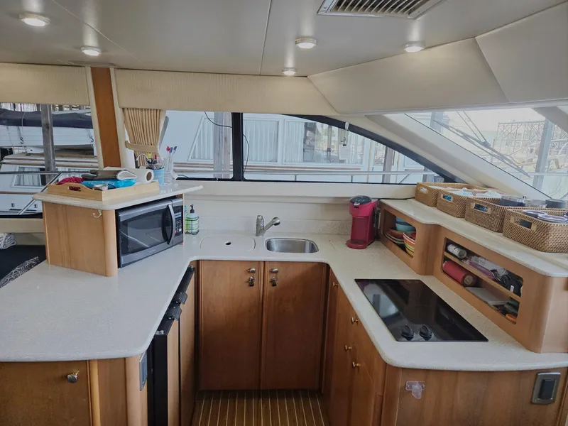 Slide: The Image of Kitchen area of a 2004 Meridian 381 Sedan yacht with modern amenities. - 40