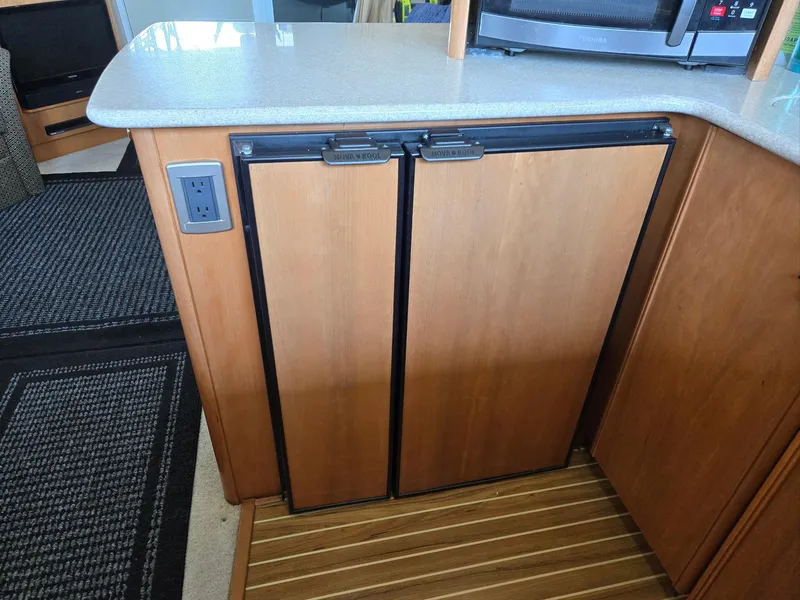Slide: The Image of Wooden cabinet with double doors in a 2004 Meridian 381 Sedan yacht interior. - 42