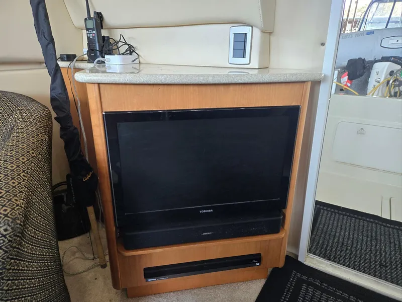 Slide: The Image of Entertainment center inside 2004 Meridian 381 Sedan yacht with TV and electronic devices. - 50