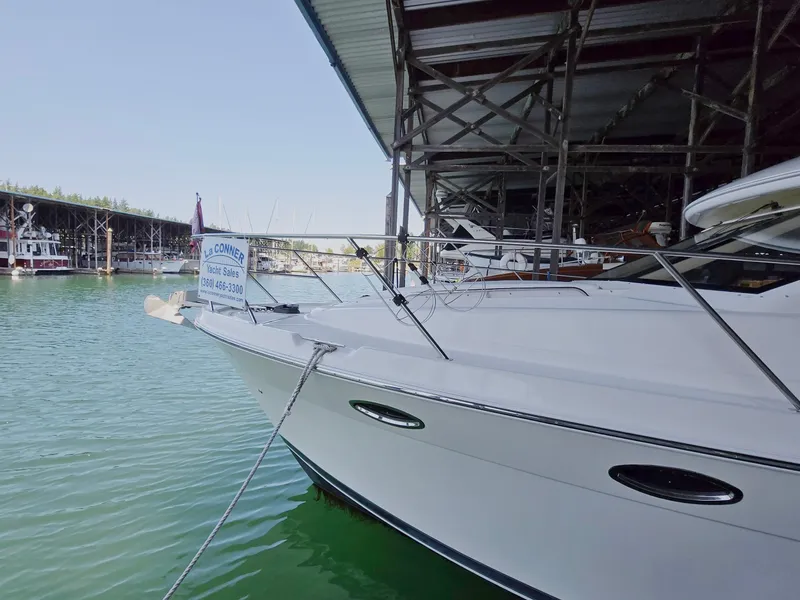 Slide: The Image of 2004 Meridian 381 Sedan yacht docked in marina, partially covered, with calm water. - 7