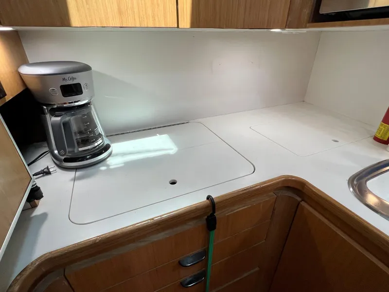 Slide: The Image of 1996 Tiara Yachts 4300 Open kitchen with coffee maker and wooden cabinetry. - 30