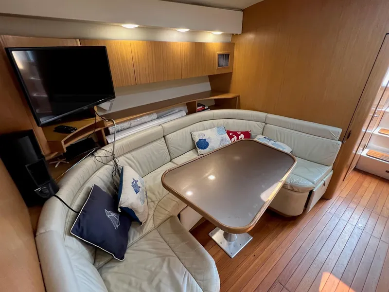 Slide: The Image of 1996 Tiara Yachts 4300 Open interior with leather seating, wooden flooring, and mounted TV. - 35