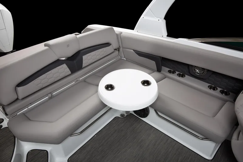 Slide: The Image of 2026 Four Winns HD8 boat interior with gray seating and round table. - 17