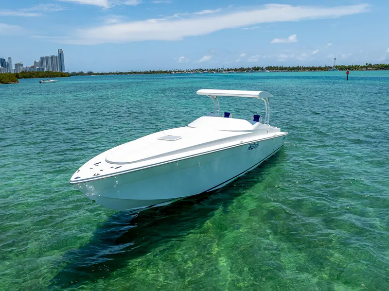 Slide: The Image of Nova 39 Sport 2020 boat on clear turquoise water, city skyline in background. - 10