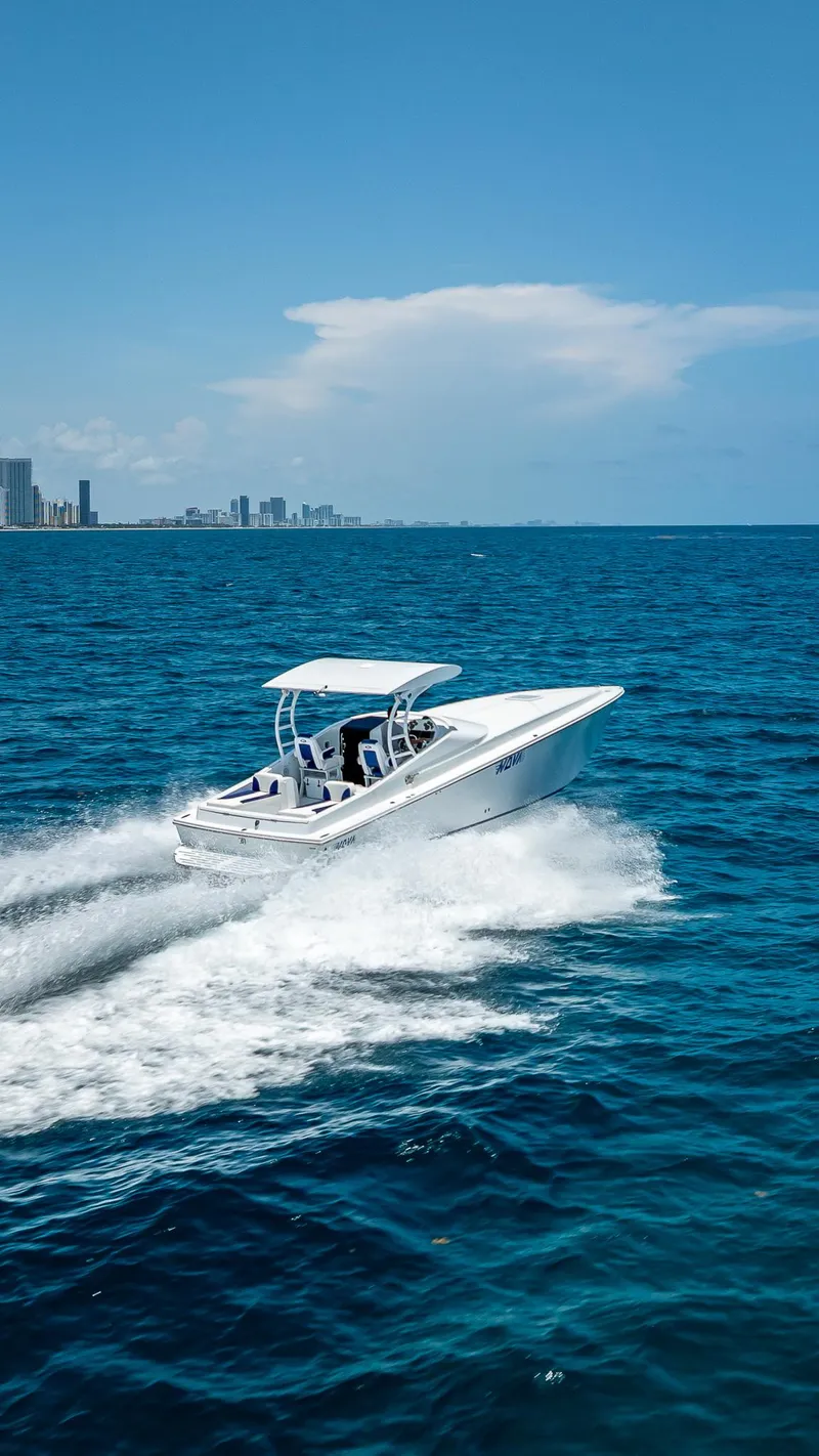 Slide: The Image of Nova 39 Sport boat cruising on blue ocean near city skyline, 2020 model. - 11