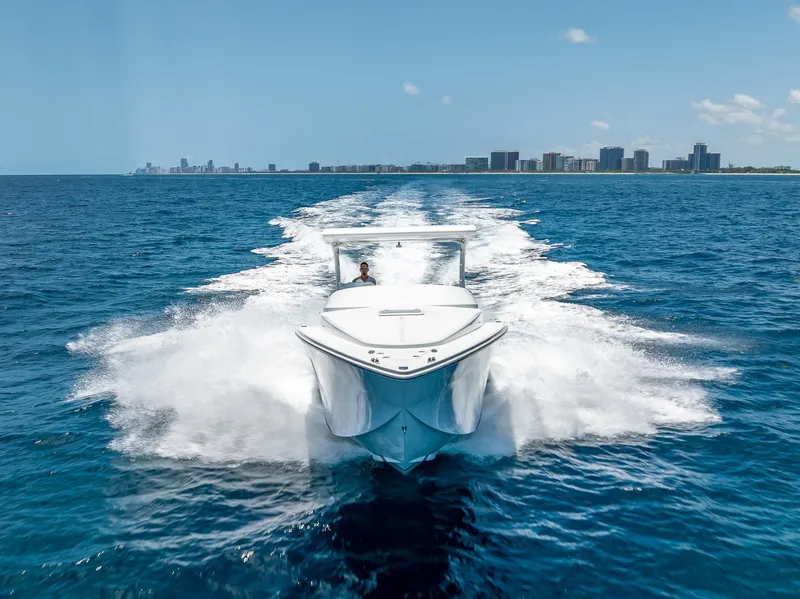 Slide: The Image of Nova 39 Sport 2020 boat cruising on open ocean with city skyline in background. - 14