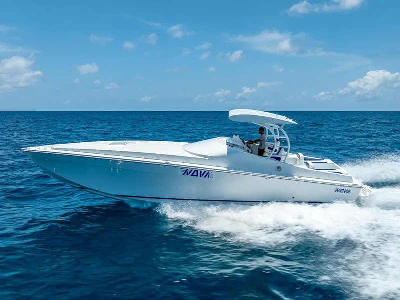 Slide: The Image of 2020 Nova 39 Sport boat cruising on open ocean under clear blue sky. - 16