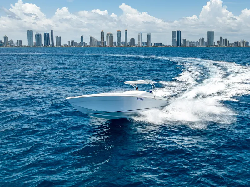 Slide: The Image of Nova 39 Sport 2020 boat cruising on ocean with city skyline in background. - 20