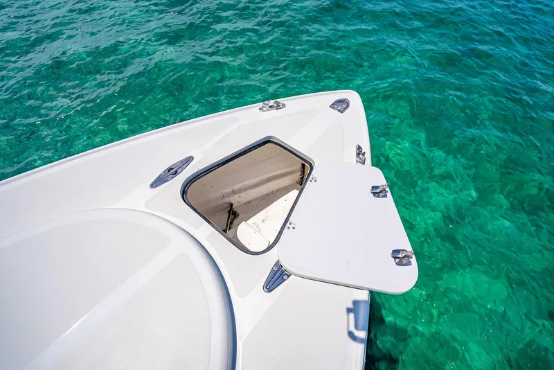 Slide: The Image of Nova 39 Sport 2020 boat deck with open hatch over clear turquoise water. - 31