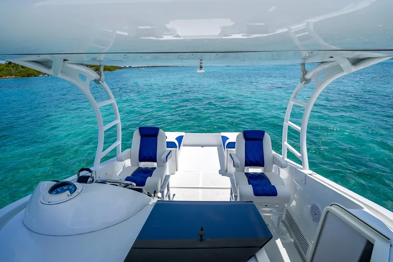 Slide: The Image of Nova 39 Sport 2020 boat with blue seats on clear turquoise water. - 34