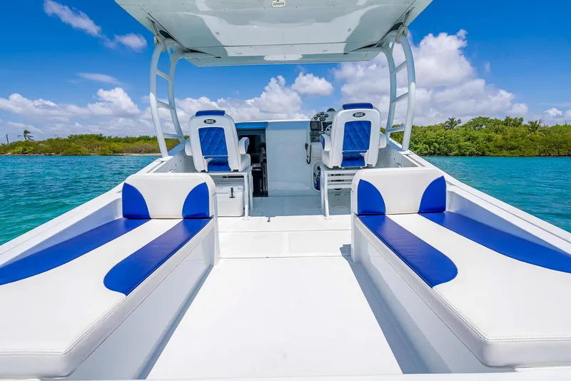 Slide: The Image of 2020 Nova 39 Sport boat with blue and white seating on clear water. - 44