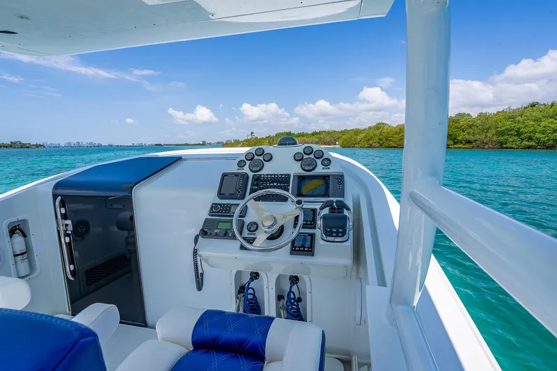 Slide: The Image of Cockpit of 2020 Nova 39 Sport boat with blue seating, steering wheel, and navigation equipment. - 46