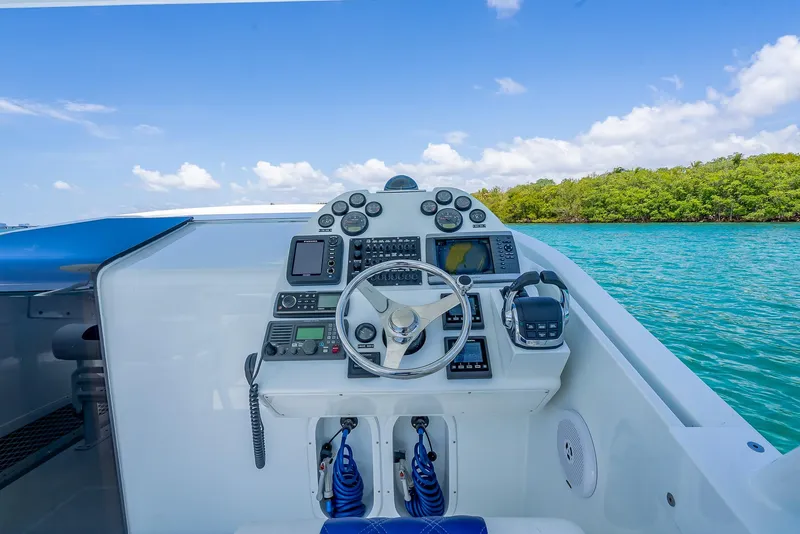 Slide: The Image of Cockpit of 2020 Nova 39 Sport boat with steering wheel and control panel, on turquoise water. - 47