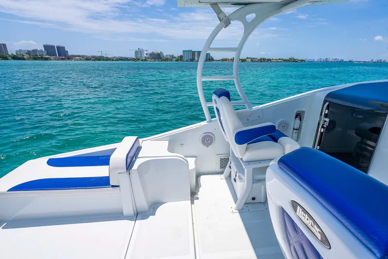 Slide: The Image of Nova 39 Sport 2020 boat with blue and white seating on clear ocean water. - 49