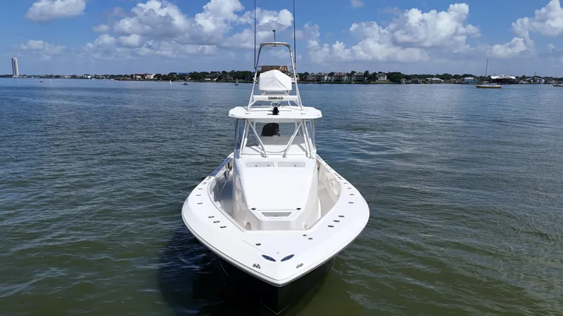Slide: The Image of 2015 SeaVee 43 Fish-Around boat on calm water under a partly cloudy sky. - 12