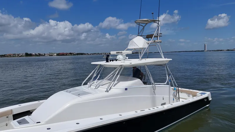 Slide: The Image of 2015 SeaVee 43 Fish-Around boat on calm water under blue sky. - 14