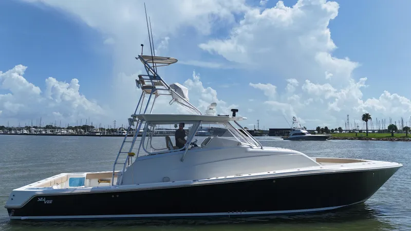 Slide: The Image of 2015 SeaVee 43 Fish-Around boat on calm water under a blue sky. - 17