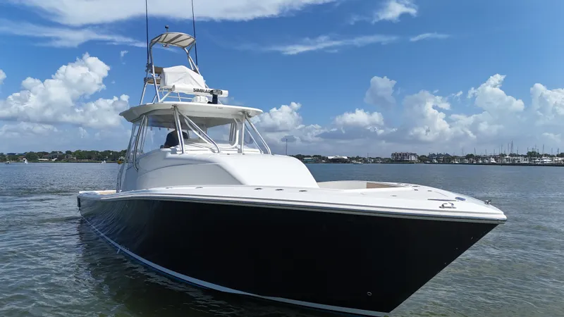 Slide: The Image of 2015 SeaVee 43 Fish-Around boat on calm water under a blue sky. - 19