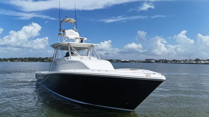Slide: The Image of 2015 SeaVee 43 Fish-Around boat on calm water under blue sky. - 20