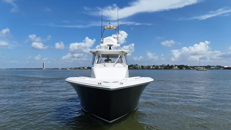 Slide: The Image of 2015 SeaVee 43 Fish-Around boat on calm water under blue sky. - 21