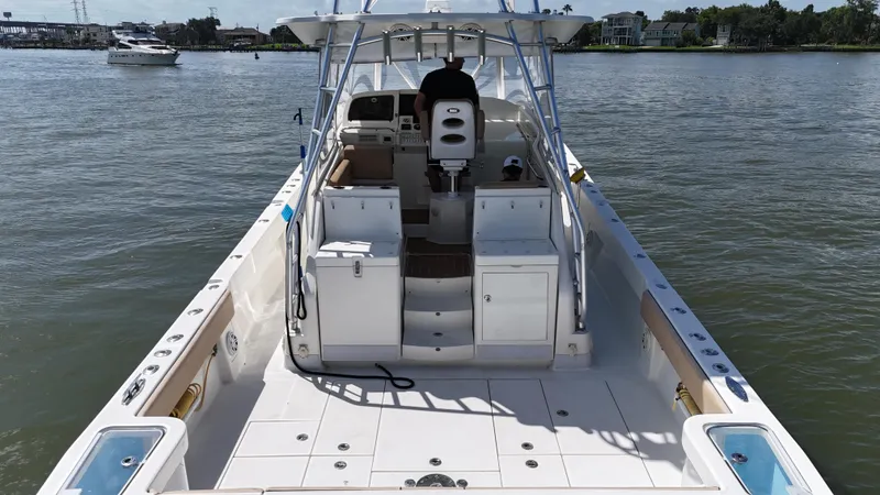 Slide: The Image of 2015 SeaVee 43 Fish-Around boat on water, featuring spacious deck and helm. - 29