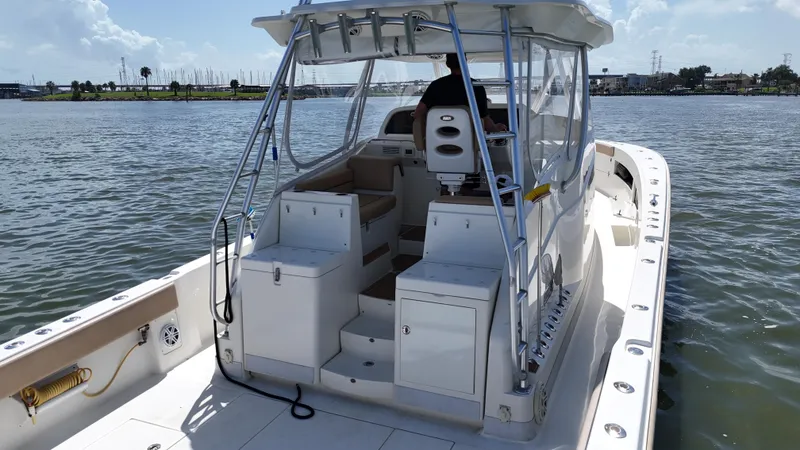 Slide: The Image of 2015 SeaVee 43 Fish-Around boat on water, featuring spacious deck and helm. - 35