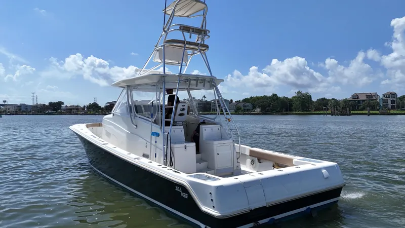 Slide: The Image of 2015 SeaVee 43 Fish-Around boat on calm water, clear sky background. - 37