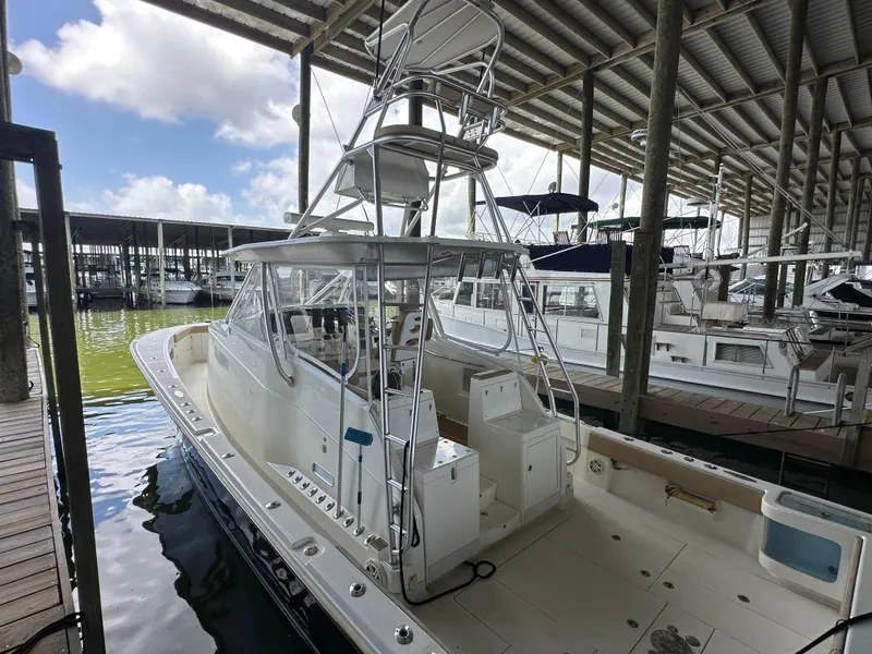 Slide: The Image of 2015 SeaVee 43 Fish-Around boat docked in a marina under a covered structure. - 44