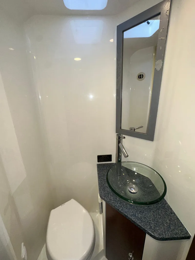 Slide: The Image of 2015 SeaVee 43 Fish-Around bathroom with modern sink and mirror. - 70