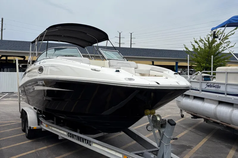 Slide: The Image of 2012 Sea Ray 260 Sundeck boat on trailer, parked outdoors. - 10