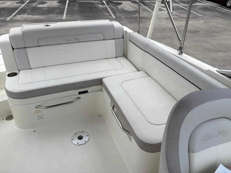 Slide: The Image of 2012 Sea Ray 260 Sundeck interior with white seating and stainless steel accents. - 13