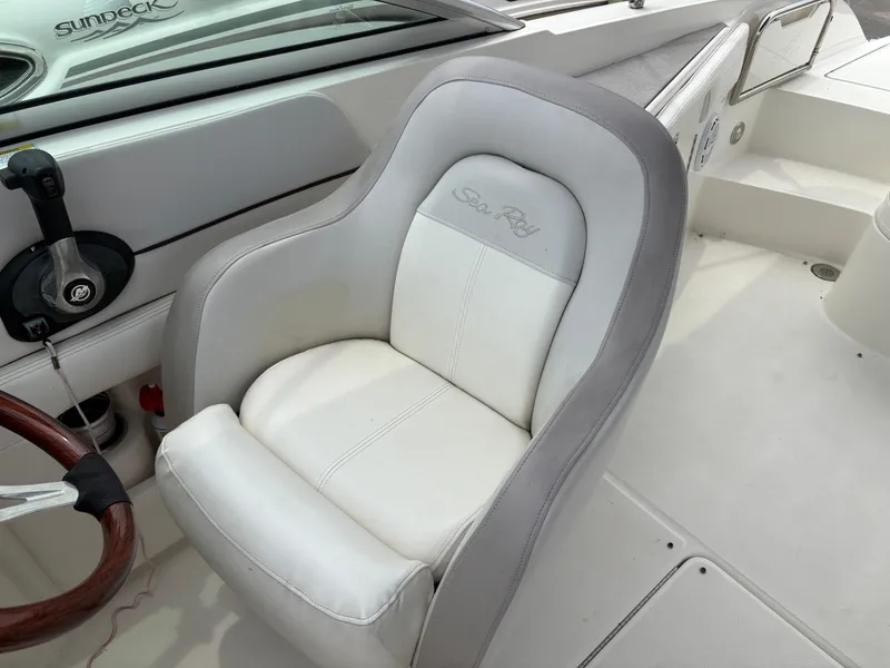Slide: The Image of 2012 Sea Ray 260 Sundeck boat seat with steering wheel and control panel. - 14